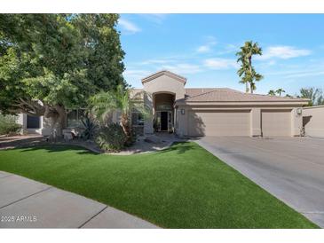 Beautiful two-story home with a three-car garage and manicured lawn at 12056 E Bella Vista Cir, Scottsdale, AZ 85259