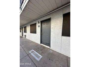 Exterior view of a building showing a walkway and multiple apartment entrances at 18202 N Cave Creek Rd # 108, Phoenix, AZ 85032