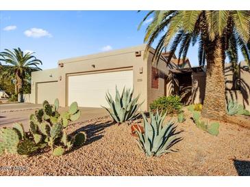 Desert landscaping surrounds this single-level home with a two-car garage at 26247 N El Prado --, Rio Verde, AZ 85263