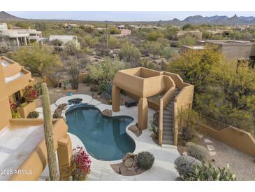 Aerial view of a luxurious pool and patio area with desert landscape at 30600 N Pima Rd # 63, Scottsdale, AZ 85266