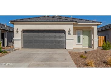 New single-story home with a two-car garage and desert landscaping at 3210 W Stradling Ave, Apache Junction, AZ 85120