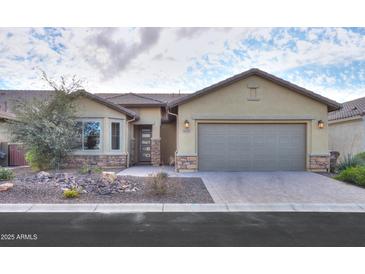 Single-story home with neutral color scheme and two-car garage at 4347 W White Horse Blvd, Eloy, AZ 85131