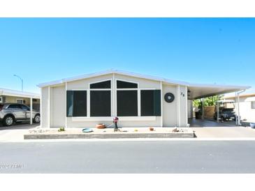 Inviting exterior of manufactured home with carport and landscaping at 5735 E Mcdowell Rd # 38, Mesa, AZ 85215