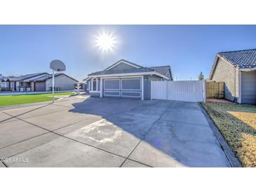 House exterior with artificial turf, fountain, and basketball hoop at 8021 W Charter Oak Rd, Peoria, AZ 85381