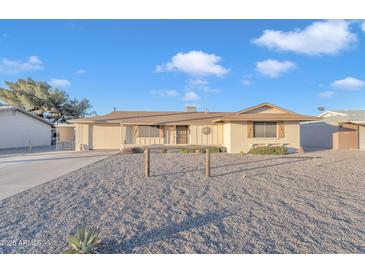 Ranch style home with gravel landscaping and a two-car garage at 10314 W Sun City Blvd, Sun City, AZ 85351