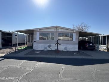 Mobile home with carport and landscaping at 11411 N 91St Ave # 221, Peoria, AZ 85345