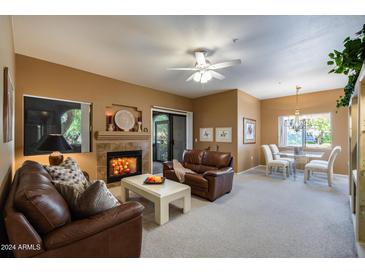 Spacious living room with fireplace and comfortable leather sofas at 15050 N Thompson Peak Pkwy # 1059, Scottsdale, AZ 85260