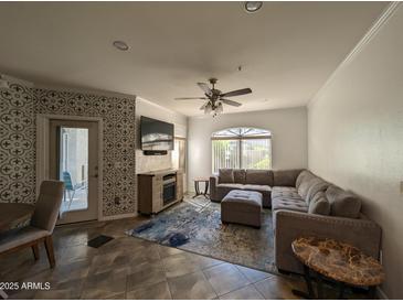 Spacious living room with L-shaped sectional sofa and a fireplace at 15095 N Thompson Peak Pkwy # 1047, Scottsdale, AZ 85260