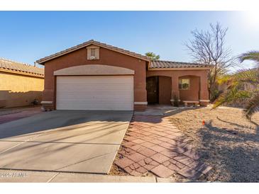 Single-story house with attached garage and desert landscaping at 16173 W Monroe St, Goodyear, AZ 85338