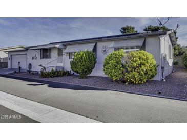 Single-wide manufactured home with carport and nicely landscaped front yard at 17200 W Bell Rd # 2255, Surprise, AZ 85374