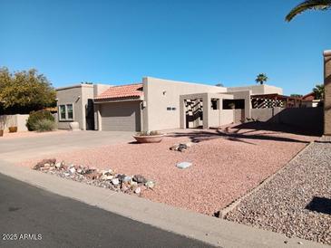 Single-story home with desert landscaping and a two-car garage at 25417 S Kansas Ave, Sun Lakes, AZ 85248