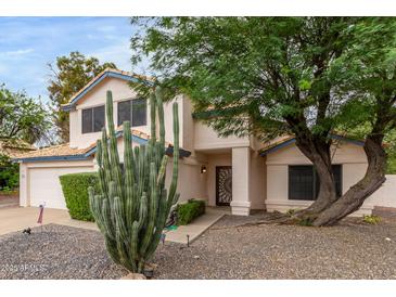 Two-story house with desert landscaping, a two-car garage, and a decorative front door at 3034 N Ricardo --, Mesa, AZ 85215