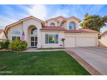 Two-story house with a landscaped lawn, attached garage, and neutral color scheme at 3124 N Sage Cir, Avondale, AZ 85392