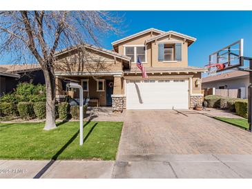 Two-story house with a large front yard, basketball hoop, and two-car garage at 4058 E Mesquite St, Gilbert, AZ 85296