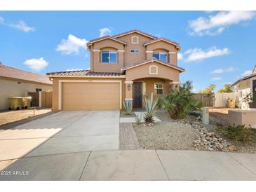 Two-story house with tan exterior, landscaped yard, and a two-car garage at 5415 W Pontiac Dr, Glendale, AZ 85308