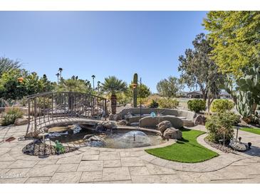 Serene backyard with a pond, bridge, and fountain, creating a relaxing atmosphere at 5500 N Globe Dr, Eloy, AZ 85131