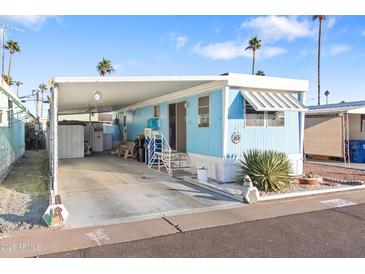 Inviting mobile home with carport and landscaped yard at 7807 E Main St # B-15, Mesa, AZ 85207