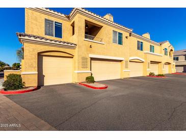 Tan colored stucco building with multiple attached garages at 900 S Canal Dr # 224, Chandler, AZ 85225