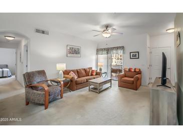 Bright living room with comfy seating, a coffee table, and access to a patio at 10136 E Southern Ave # 1045, Mesa, AZ 85209