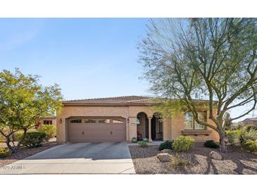 Single-story home with a two-car garage and landscaped front yard at 12975 W Andrew Ln, Peoria, AZ 85383