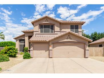 Two-story house with a three-car garage and desert landscaping at 18877 N 59Th Dr, Glendale, AZ 85308