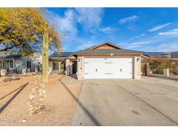 Charming single-story home featuring a two-car garage, xeriscaped yard, and solar panels at 21063 N 33Rd Ln, Phoenix, AZ 85027