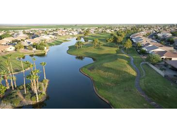 Aerial view of a community with houses, golf course, and lake at 23901 S Vacation Way, Sun Lakes, AZ 85248