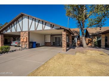 Brick home with carport and small front yard at 3344 E Crescent Ave, Mesa, AZ 85204