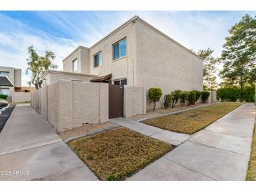 Tan two-story condo building with a courtyard and walkway at 4140 N 81St St, Scottsdale, AZ 85251