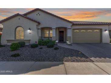 Single-story home with a two-car garage and landscaped front yard at 41925 W Arvada Ln, Maricopa, AZ 85138