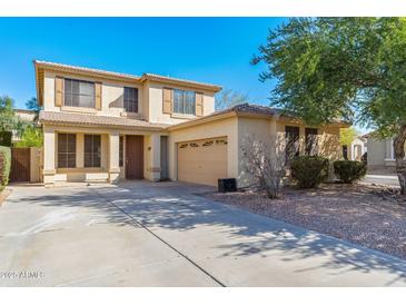 Two-story home featuring a neutral stucco facade, attached garage, and desert landscaping under a clear blue sky at 60 W Beechnut Pl, Chandler, AZ 85248