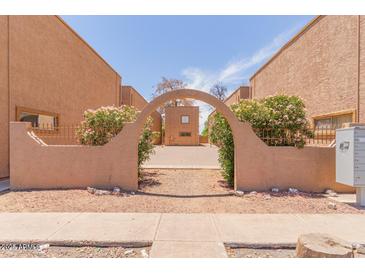 Tan colored buildings with courtyard and arched entryway at 6302 N 64Th Dr # 4, Glendale, AZ 85301