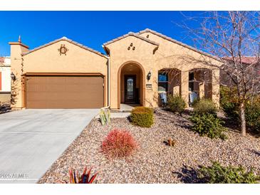 Single-story home with desert landscaping and a two-car garage at 8088 W Cinder Brook Way, Florence, AZ 85132