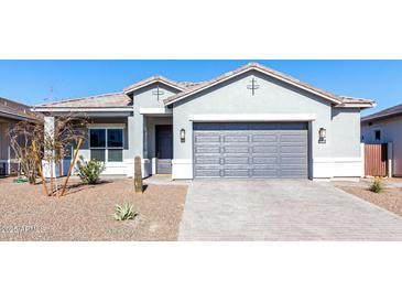 Single-story home with gray exterior, two-car garage, and desert landscaping at 10488 W Deanna Dr, Peoria, AZ 85382