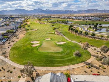 Aerial view of a golf course community with mountain views at 11746 N San Clemente St, Surprise, AZ 85388