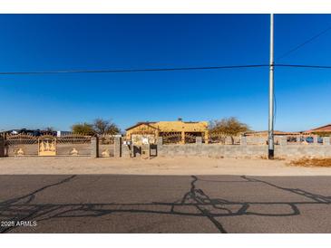 Ranch style home with decorative iron fencing at 18706 W Arlington Rd, Buckeye, AZ 85326