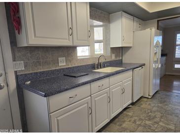 White cabinets, blue countertop kitchen at 2650 W Union Hills Dr # 33, Phoenix, AZ 85027