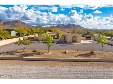 Stunning aerial view of a single-story home with a large yard and mountain views at 37415 N 24Th St, Phoenix, AZ 85086
