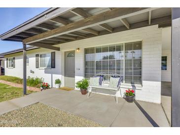 Inviting front porch with a bench, planters, and a covered area at 2502 E Elm St, Phoenix, AZ 85016