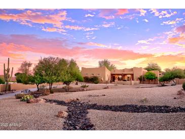 Stunning desert home with landscaped yard at sunset at 317 W Olesen Rd, Phoenix, AZ 85085