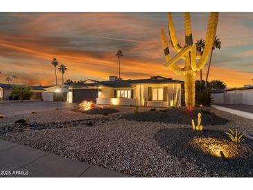 Stunning curb appeal with desert landscaping, lighting, and a large saguaro cactus at 4942 E Wethersfield Rd, Scottsdale, AZ 85254