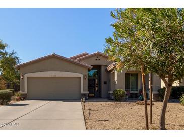 One-story house with a two-car garage and desert landscaping at 5126 S Sugarberry Ct, Gilbert, AZ 85298
