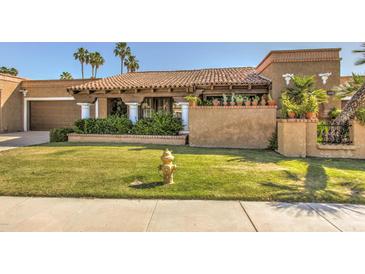 Spanish style home with tile roof, lush landscaping, and a grassy front yard at 8082 E Via Del Desierto --, Scottsdale, AZ 85258