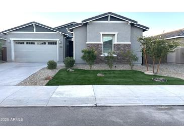 Single-story home with a two-car garage and landscaped front yard at 19202 W Coolidge St, Litchfield Park, AZ 85340