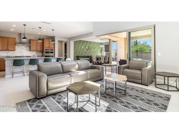 Spacious living room with high ceilings and access to backyard patio at 27165 N 71St Ln, Peoria, AZ 85383