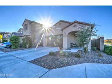 Single-story home with landscaped front yard and attached garage at 4428 N 92Nd Ln, Phoenix, AZ 85037