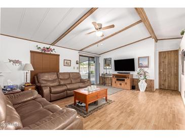 Living room with two leather sofas, coffee table, and wood floors at 9333 E University Dr # 147, Mesa, AZ 85207