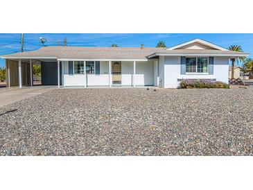 White single story home with carport and gravel driveway at 12001 N Pebble Beach Dr, Sun City, AZ 85351