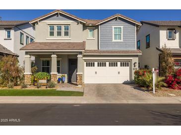 Two-story home with white garage door and landscaping at 1336 E Sierra Vista Dr, Phoenix, AZ 85014