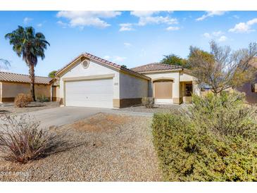 One-story house with attached garage and desert landscaping at 15742 W Watson W Ln, Surprise, AZ 85379